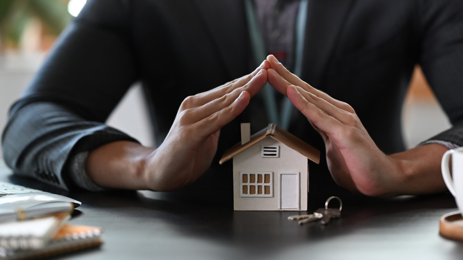 Estate agent hands over house model for protection and care. Pro Estate agent hands over house model for protection and care. Property insurance concept.